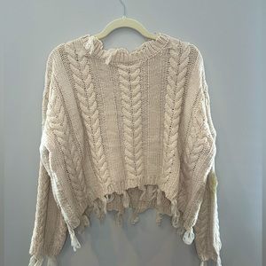 Cream cable knit sweater with frayed fringe detailing. NWT size XS